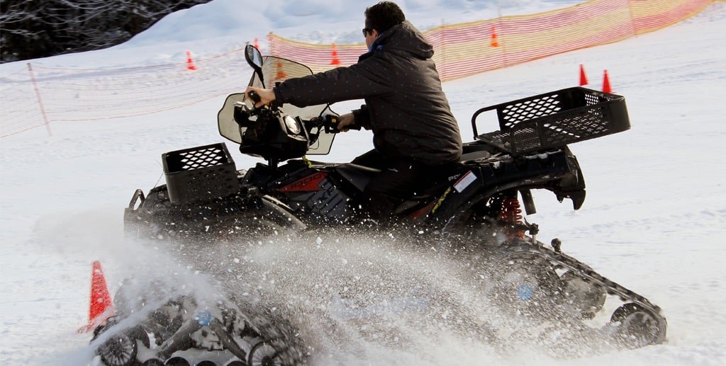 DMC in Alps – A thrill-seeker riding a snowmobile through fresh powder