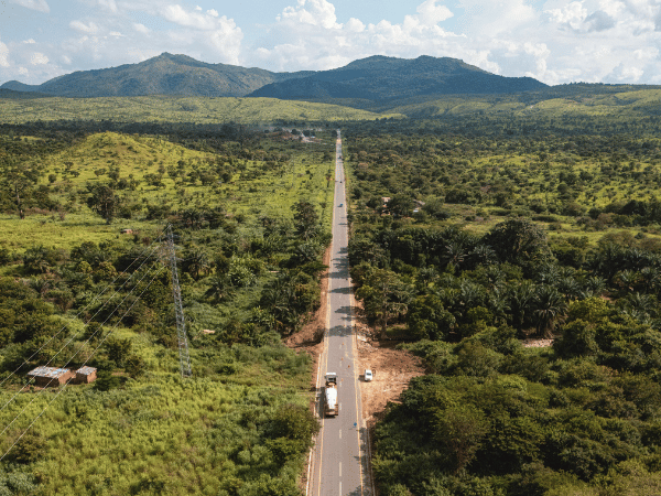 Lush green Angolan countryside with mountain views, indicating diverse natural beauty for tours.