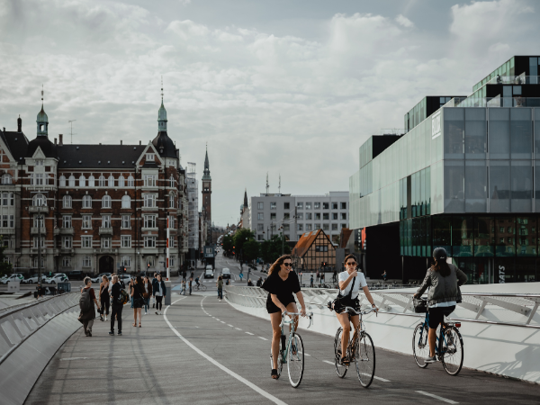 DMC in Denmark – People cycling and walking in Copenhagen, emphasizing the city’s bike-friendly streets and urban charm.