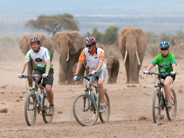  Cycling in the wild at Ol Donyo Wuas Lodge, Kenya, an exhilarating adventure offered by a DMC in Kenya.