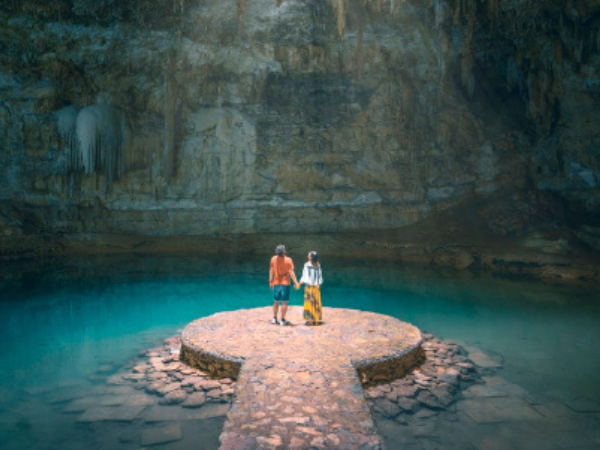 A couple admires the breathtaking Cenote Suytun in Yucatán, Mexico, a must-visit attraction curated by a DMC in Mexico.