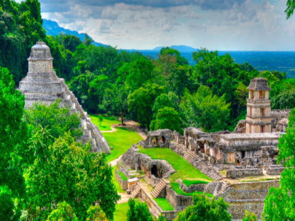 The ancient Mayan ruins of Palenque, including the Temple of the Inscriptions, surrounded by the lush jungle of Chiapas, a historic site featured in DMC in Mexico tours.