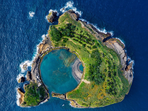 A breathtaking bird's-eye view of Ilhéu de Vila Franca in the Azores, Portugal, expertly curated by a DMC in Portugal.