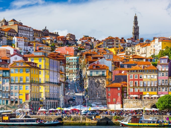 The historic Ribeira district of Porto, Portugal, a UNESCO World Heritage site, with colorful architecture and Douro River views, best explored with a DMC in Portugal.
