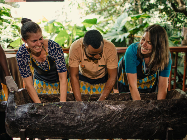 Tourists enjoying a cultural activity with a dmc in Rwanda.