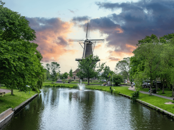 Classic Dutch windmill near canal at sunset experience with DMC in Netherlands