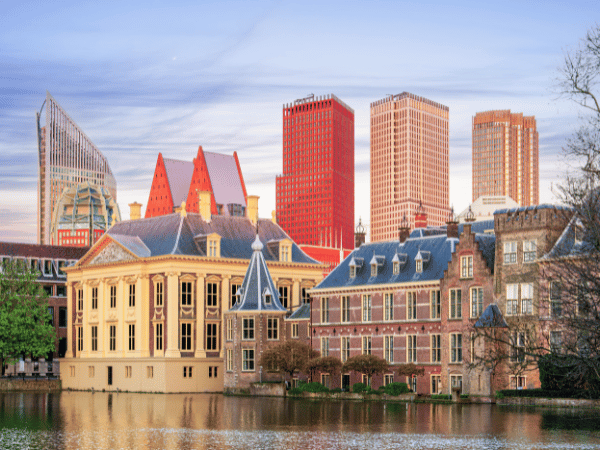 A group of people walking along a canal bridge in Amsterdam, highlighting a DMC in Netherland for group travel